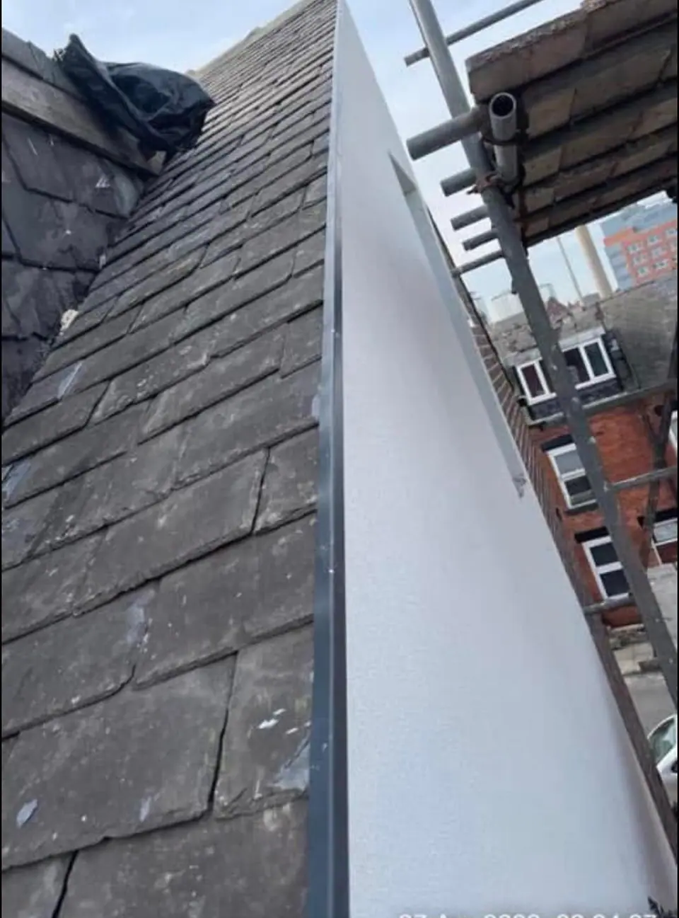 White fascia board fitted along a slate roof edge