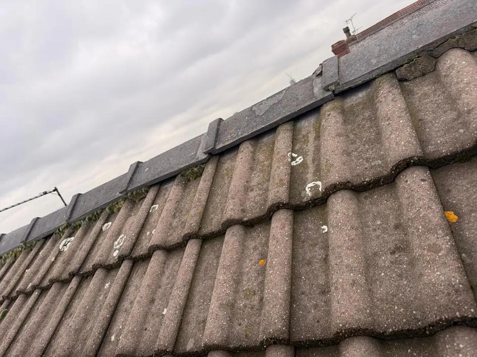 Dry ridge fittings along a pitched tiled roof